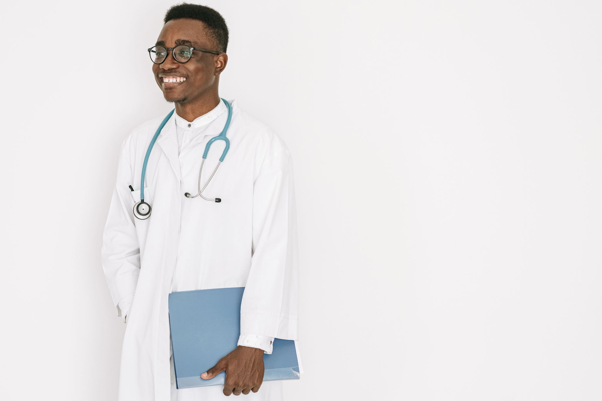 Confident doctor with stethoscope and folder, exuding professionalism and warmth.